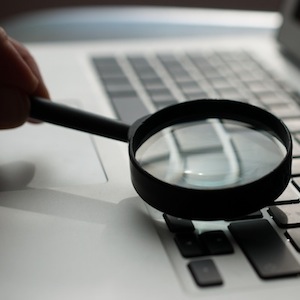 Magnifying Glass On Laptop Keyboard